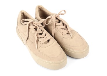 Photo of Pair of stylish beige sneakers on white background