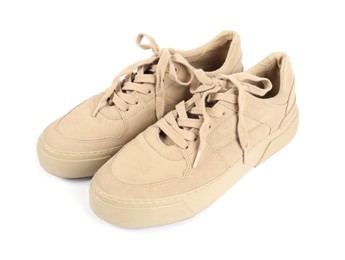Photo of Pair of stylish beige sneakers on white background
