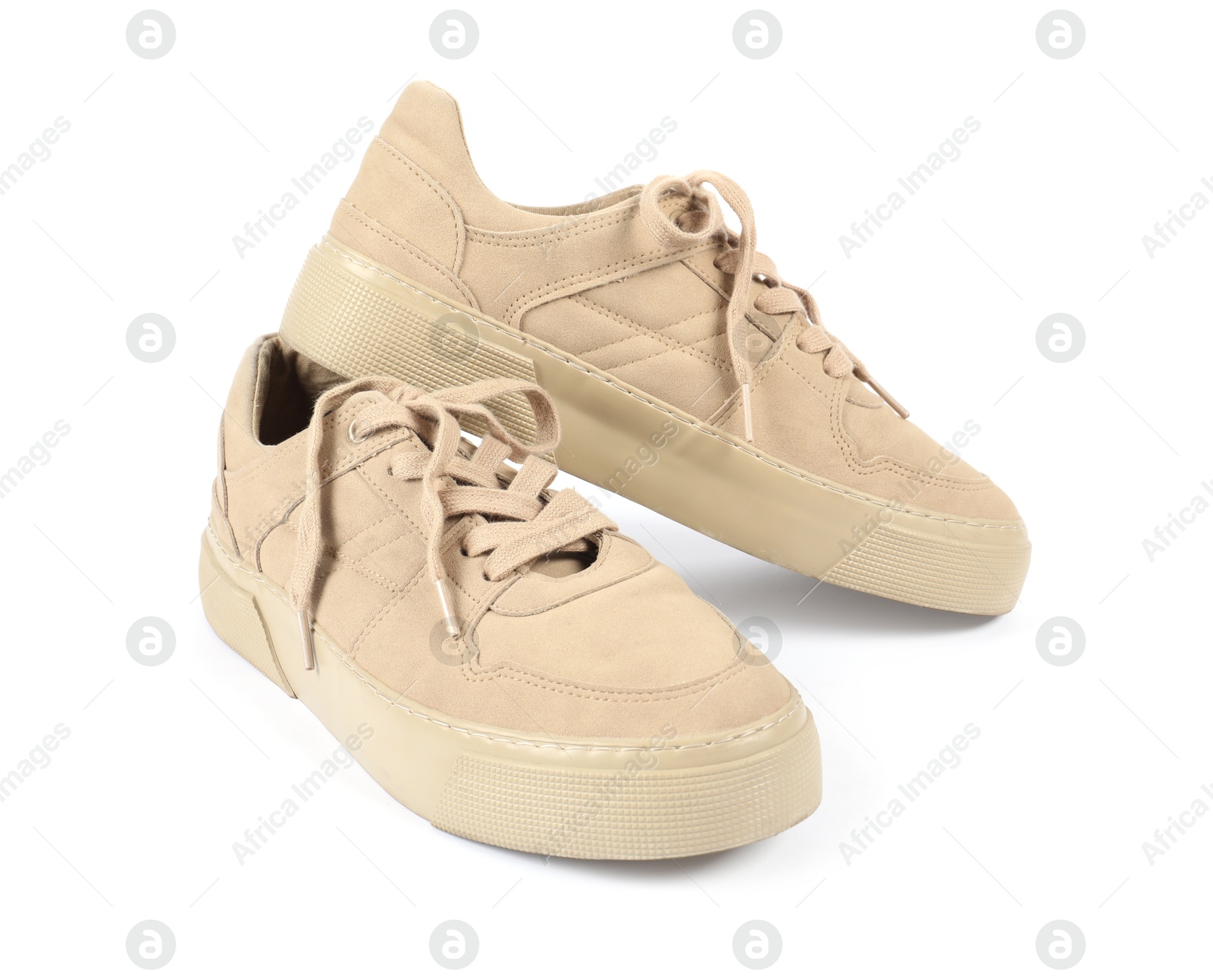 Photo of Pair of stylish beige sneakers on white background