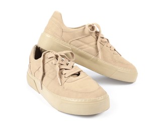 Photo of Pair of stylish beige sneakers on white background