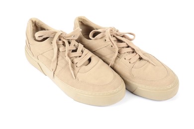 Photo of Pair of stylish beige sneakers on white background