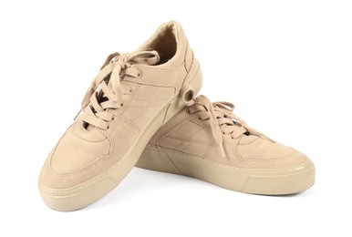Photo of Pair of stylish beige sneakers on white background