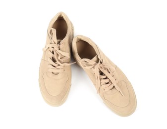 Photo of Pair of stylish beige sneakers on white background, top view