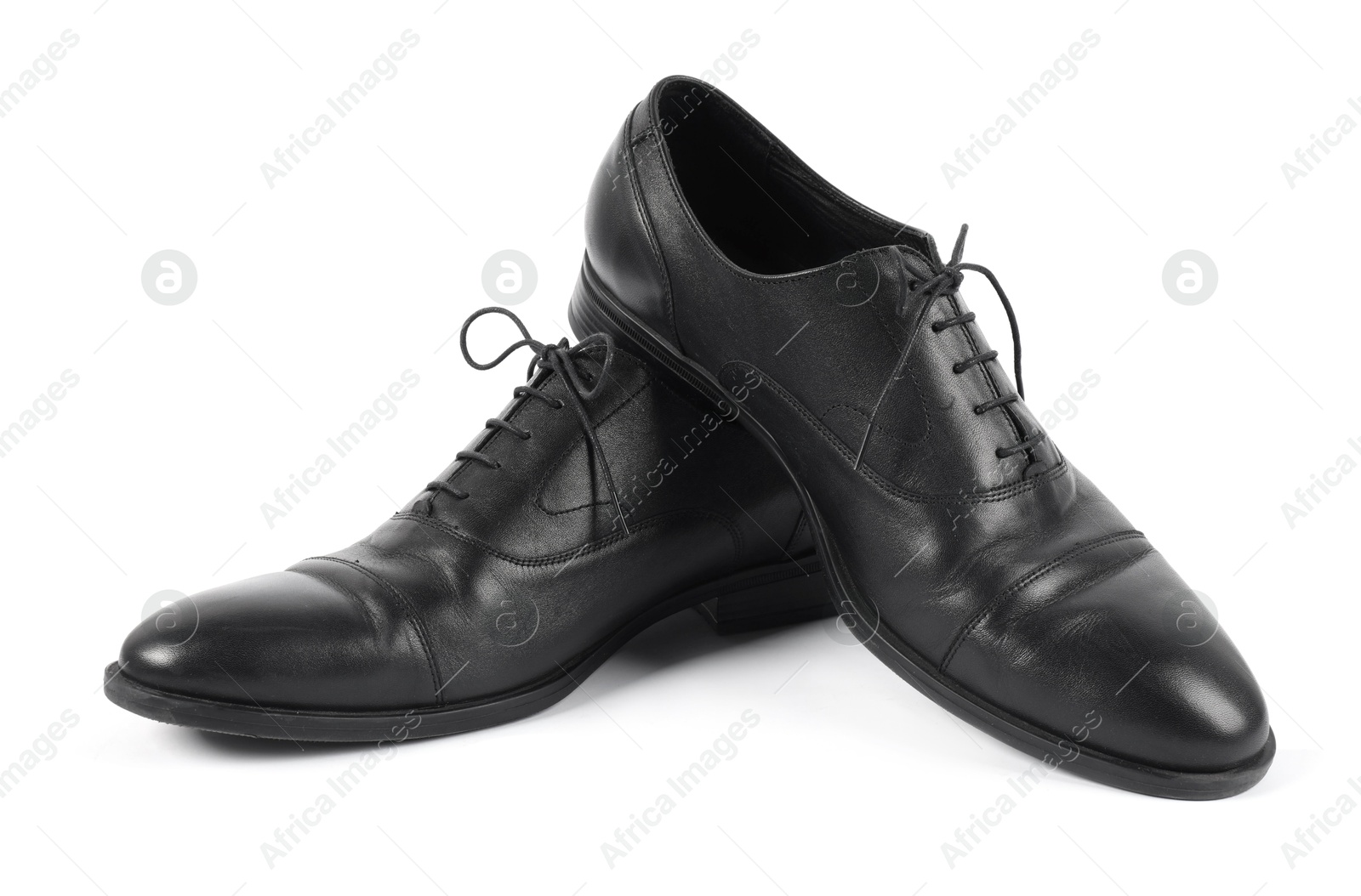 Photo of Pair of black leather shoes on white background