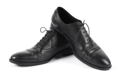 Photo of Pair of black leather shoes on white background