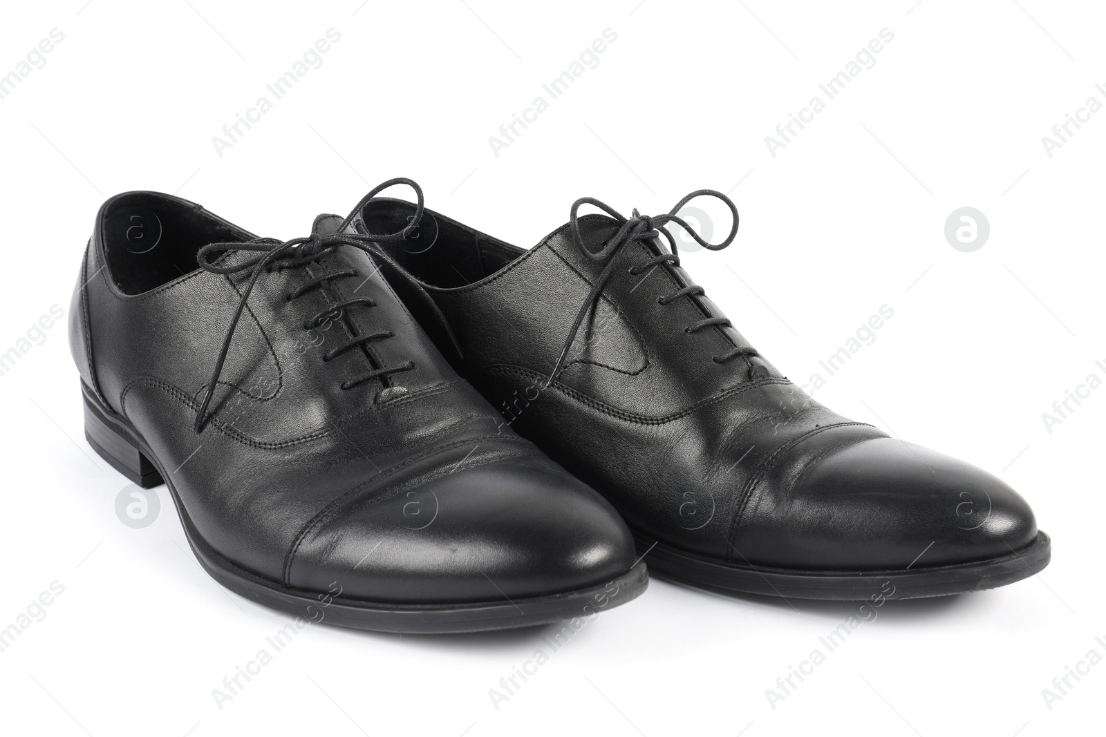Photo of Pair of black leather shoes on white background