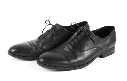 Photo of Pair of black leather shoes on white background