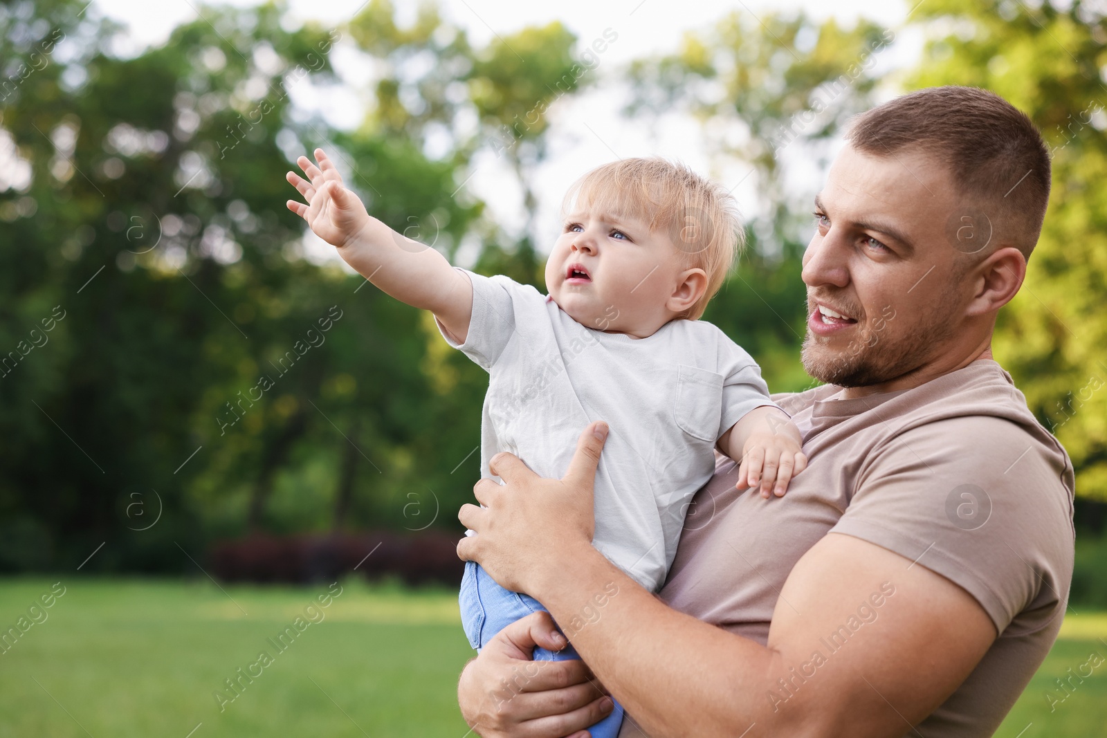 Dad with his cute newborn baby outdoors. Happy Father's Day Photo of Dad with his cute newborn baby outdoors. Happy Father's Day