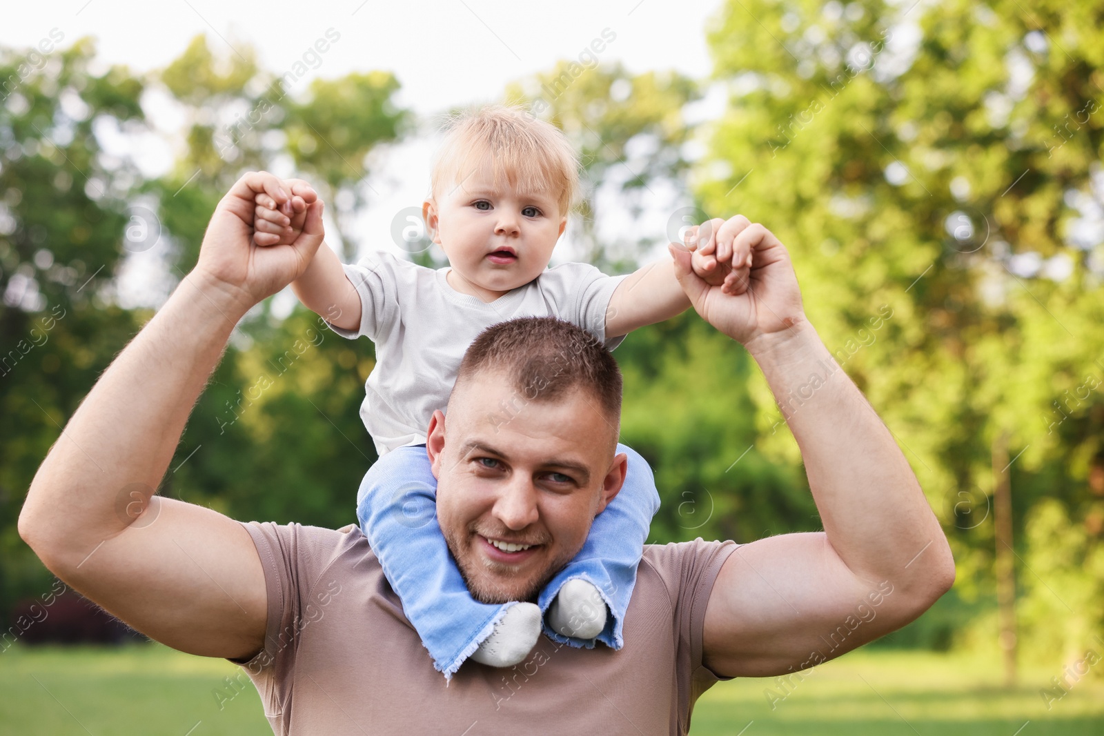 Smiling dad and his newborn baby outdoors. Happy Father's Day Photo of Smiling dad and his newborn baby outdoors. Happy Father's Day