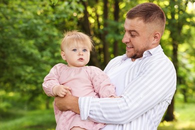 Photo of Dad and his newborn baby outdoors. Happy Father's Day