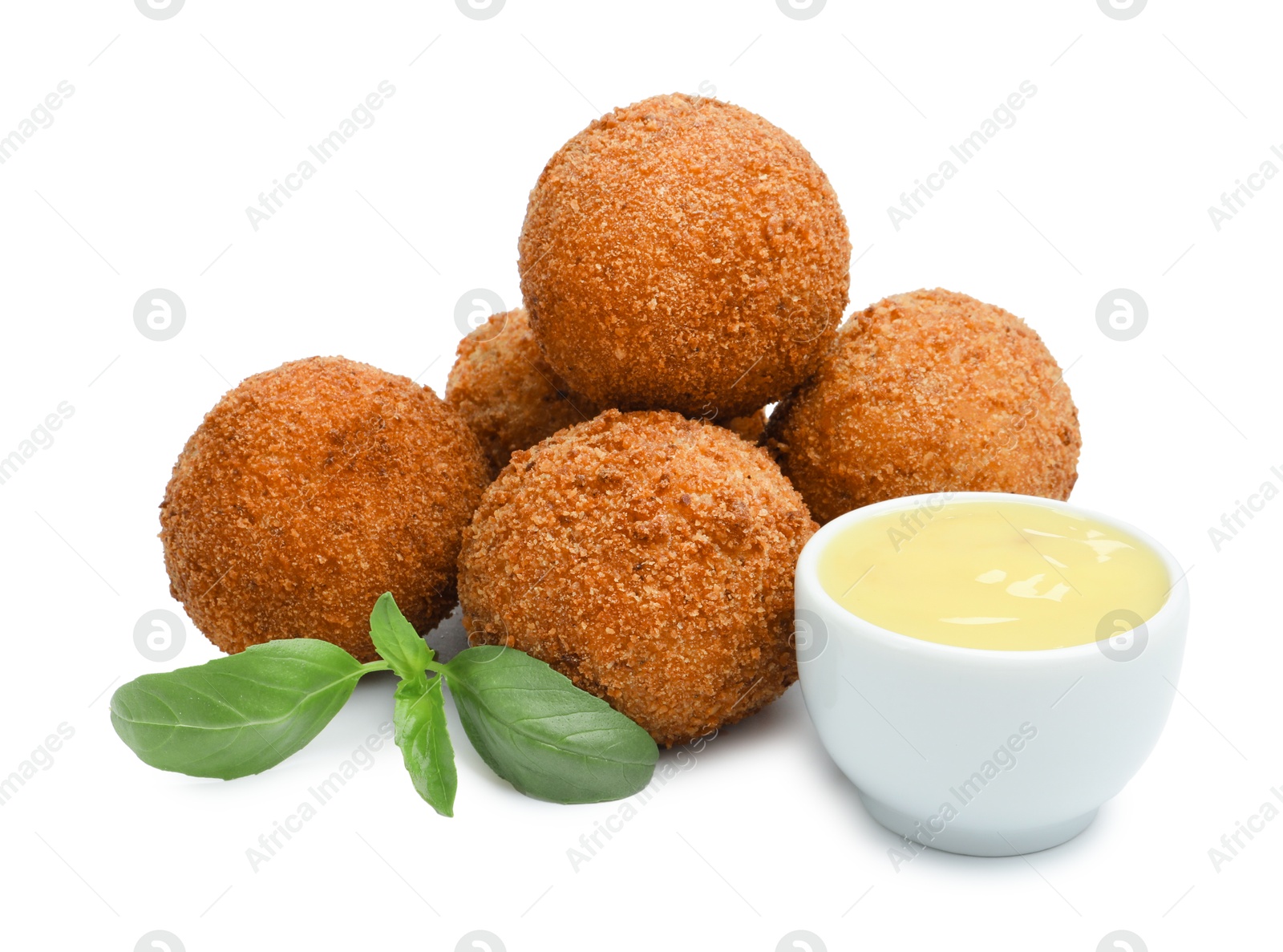 Delicious fried croquette balls, sauce and basil isolated on white Photo of Delicious fried croquette balls, sauce and basil isolated on white