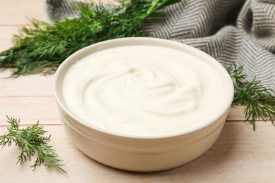 Photo of Tasty sour cream and dill on white wooden table, closeup