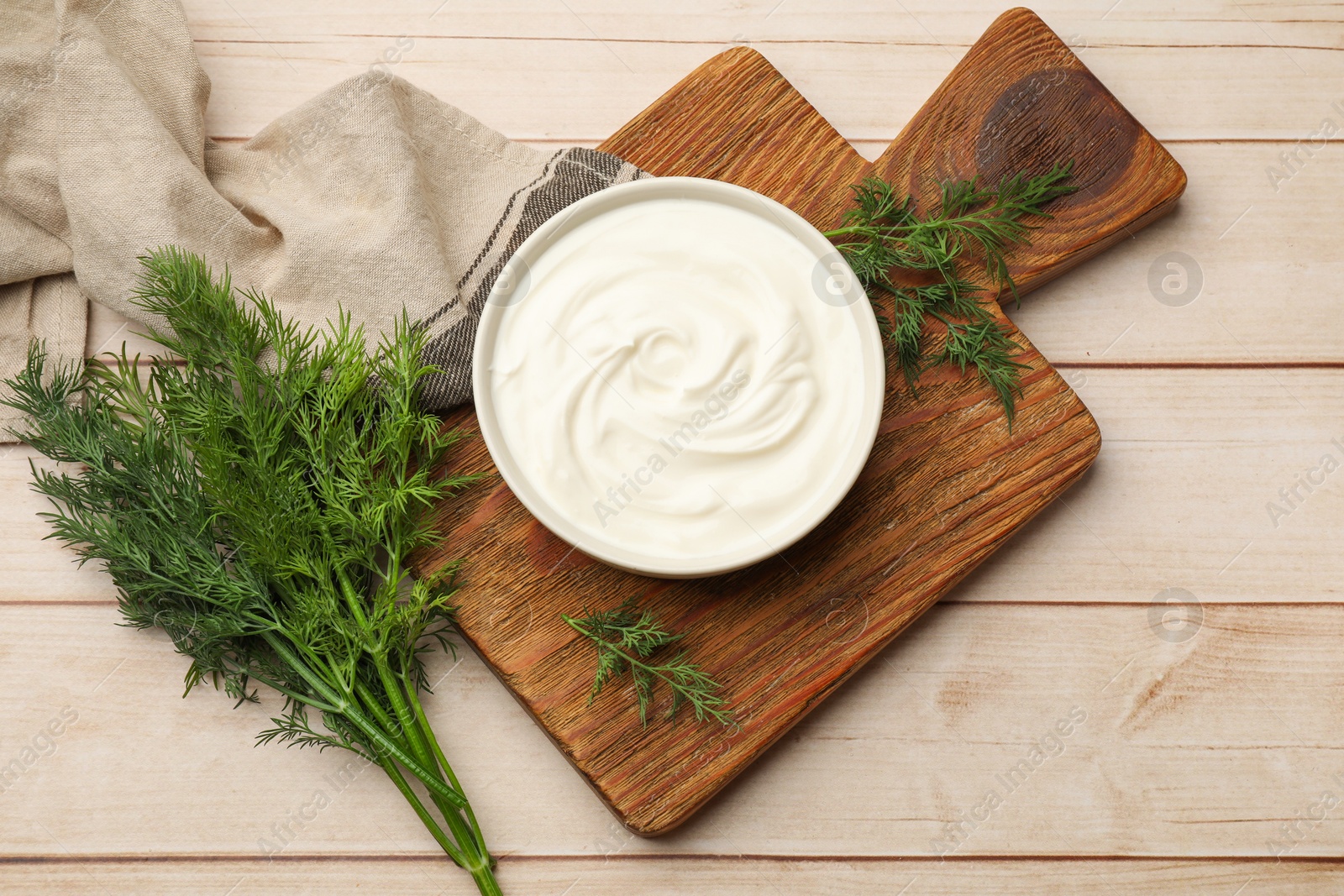 Tasty sour cream and dill on white wooden table, flat lay Photo of Tasty sour cream and dill on white wooden table, flat lay