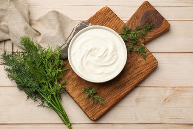 Photo of Tasty sour cream and dill on white wooden table, flat lay