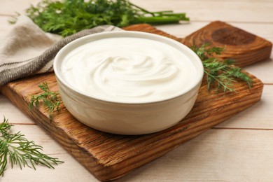 Photo of Tasty sour cream and dill on white wooden table, closeup