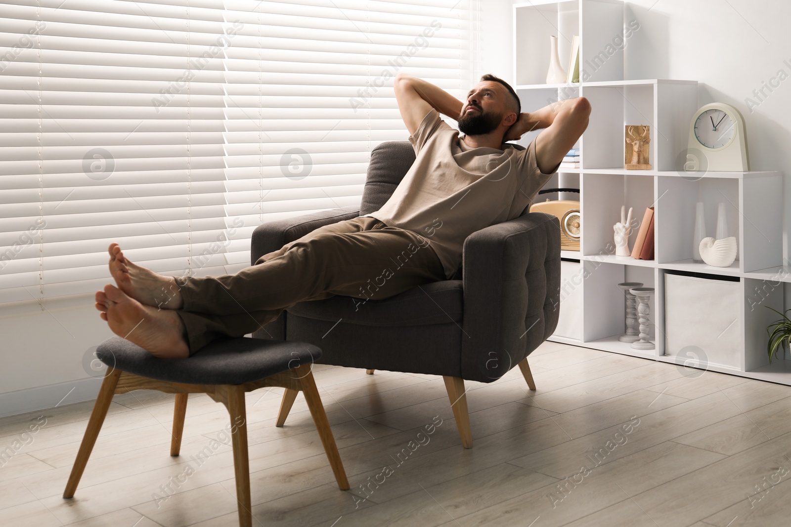 Harmony. Man relaxing in comfortable armchair at home Photo of Harmony. Man relaxing in comfortable armchair at home