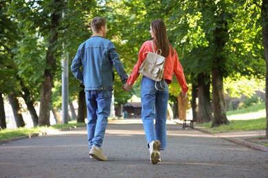 Photo of Lovely couple walking together in park on sunny day
