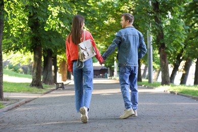 Photo of Lovely couple walking together in park on sunny day