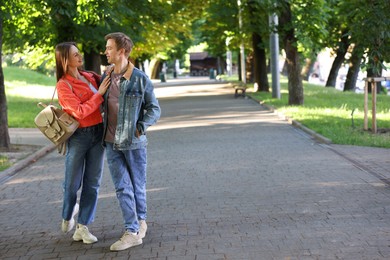 Photo of Lovely couple walking together in park, space for text