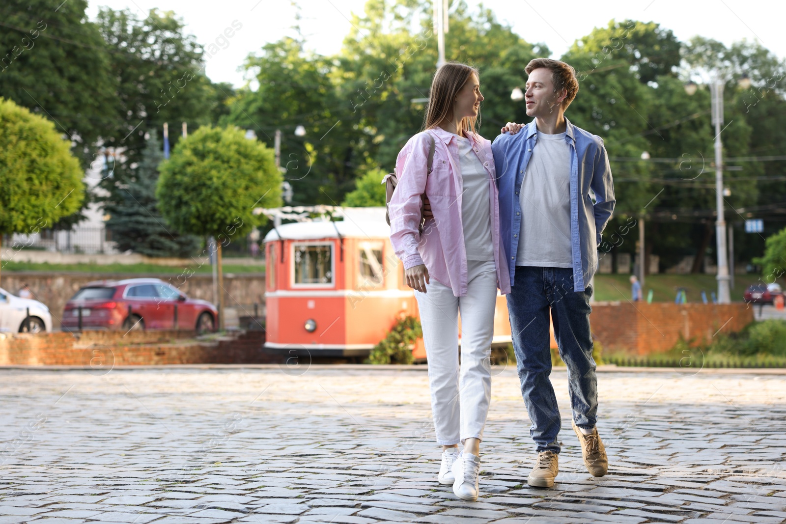 Lovely couple walking together on city street, space for text Photo of Lovely couple walking together on city street, space for text