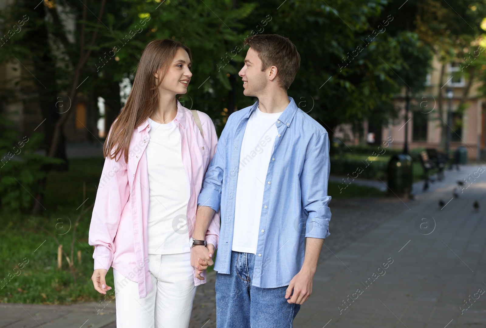 Lovely couple walking together on city street Photo of Lovely couple walking together on city street