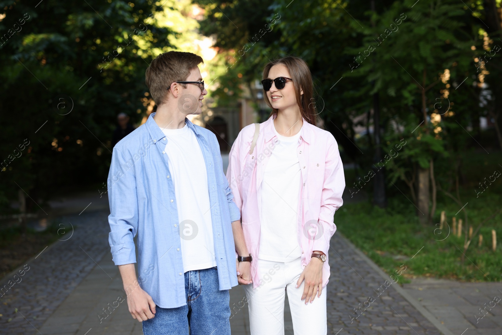 Lovely couple walking together on city street Photo of Lovely couple walking together on city street