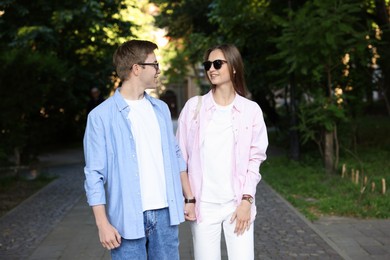 Photo of Lovely couple walking together on city street