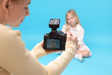 Photo of Photographer working with model in professional photo studio, selective focus