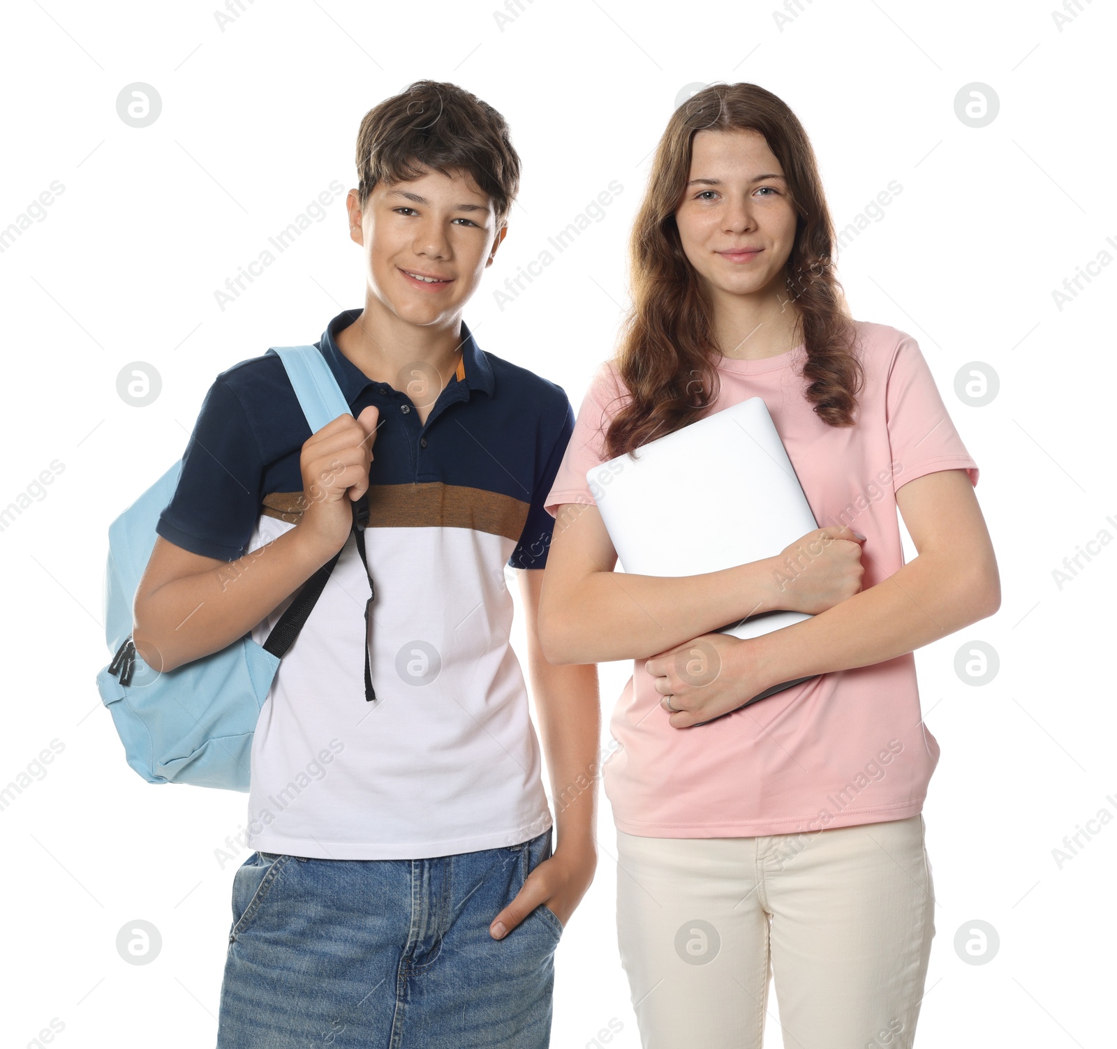 Teenage girl and boy with backpack and laptop on white background Photo of Teenage girl and boy with backpack and laptop on white background