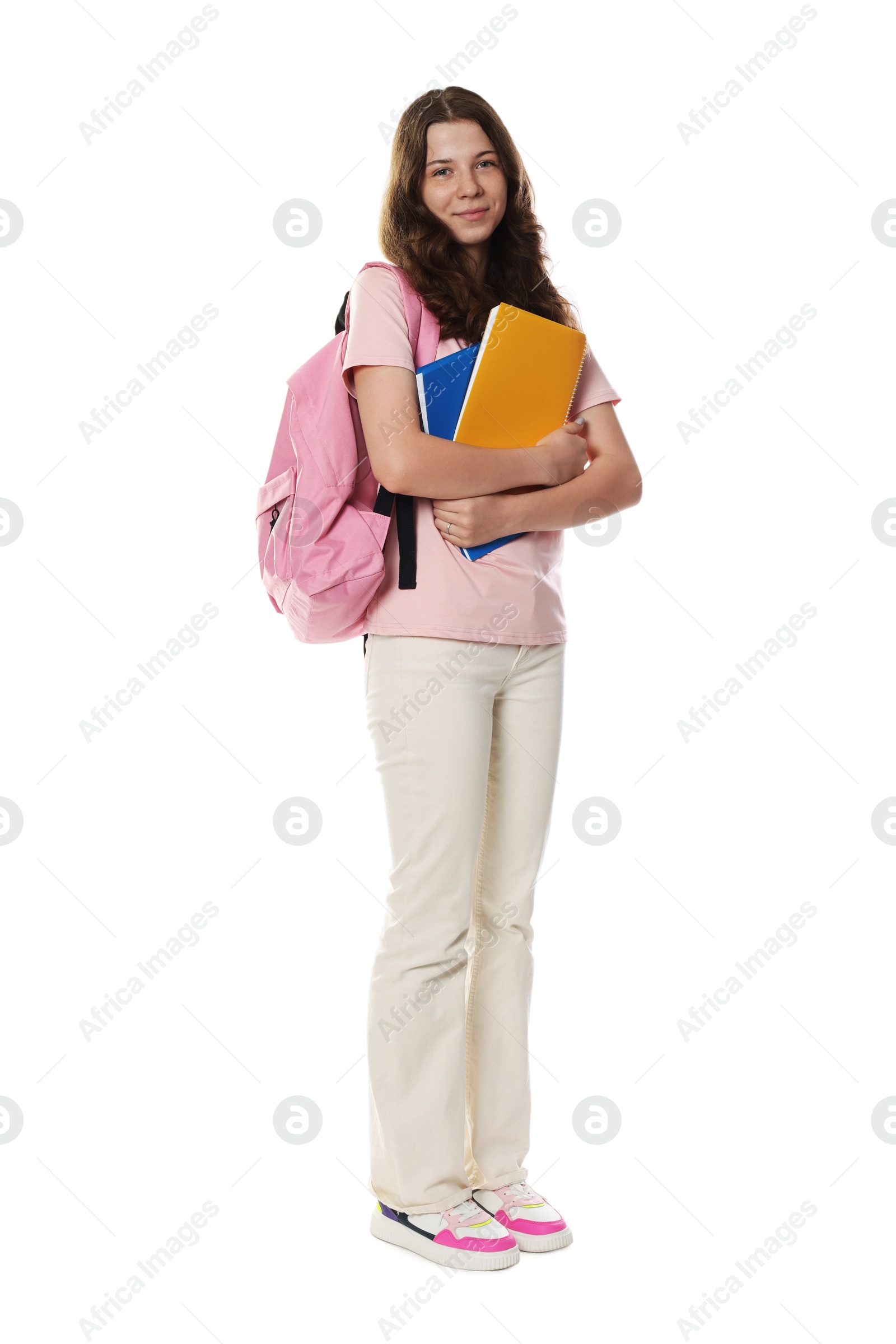 Cute teenage girl with backpack and notebooks on white background Photo of Cute teenage girl with backpack and notebooks on white background