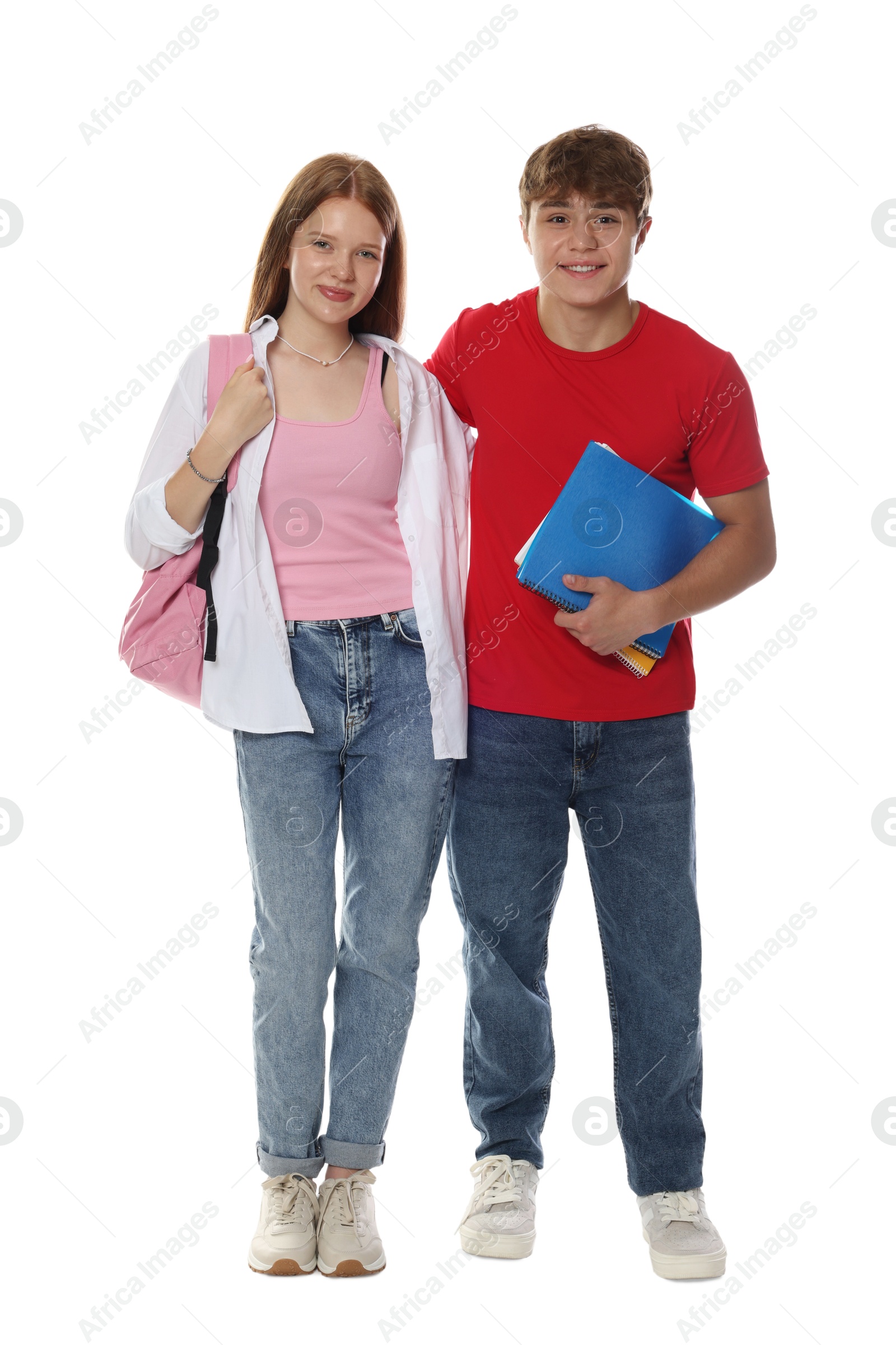 Teenage girl and boy with backpack and notebook on white background Photo of Teenage girl and boy with backpack and notebook on white background