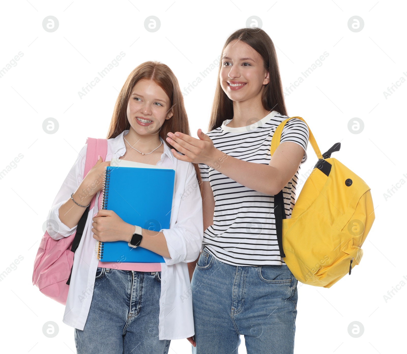 Teenage girl showing her friend something on white background Photo of Teenage girl showing her friend something on white background