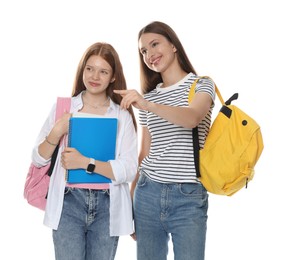 Photo of Teenage girl showing her friend something on white background