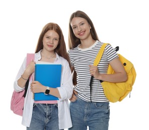 Photo of Teenage girls with backpacks and notebooks on white background