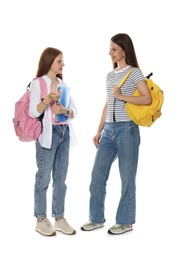 Photo of Teenage girls with backpacks and notebooks talking on white background