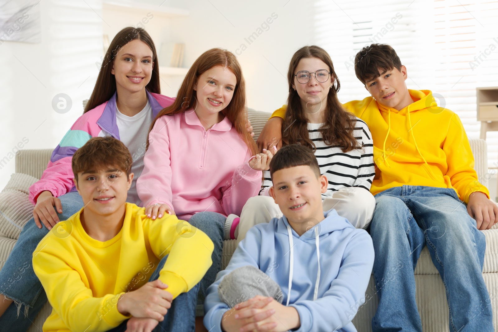 Group of happy teenagers on sofa at home Photo of Group of happy teenagers on sofa at home