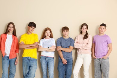 Photo of Group of teenagers near beige wall indoors