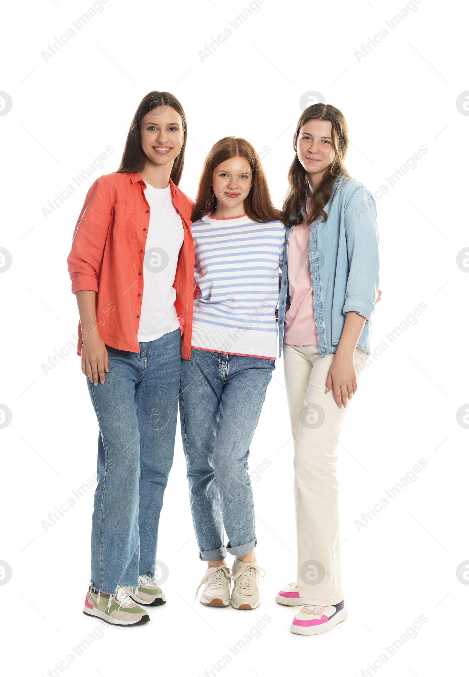 Happy teenage girls posing on white background Photo of Happy teenage girls posing on white background