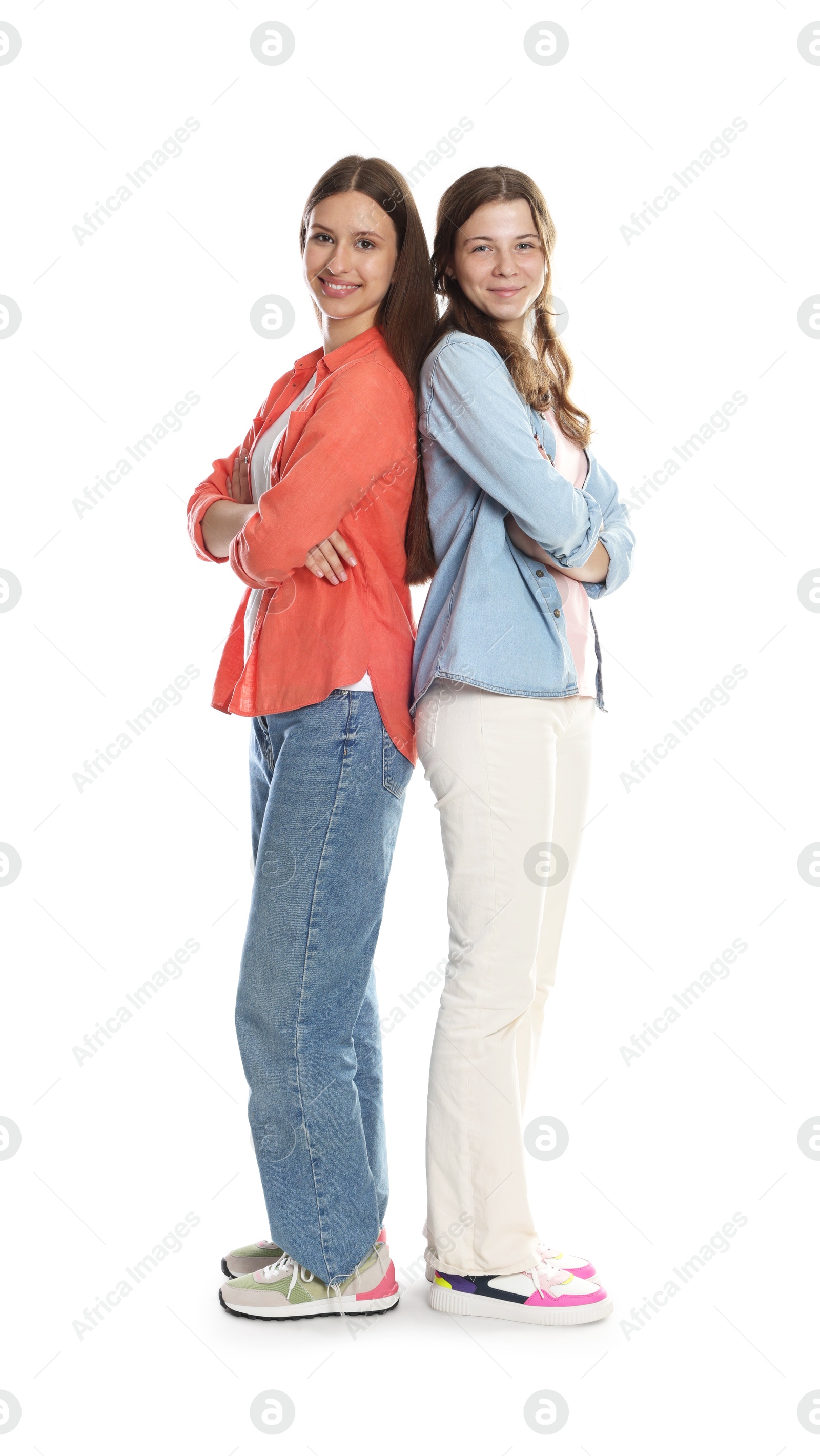 Happy teenage girls posing on white background Photo of Happy teenage girls posing on white background