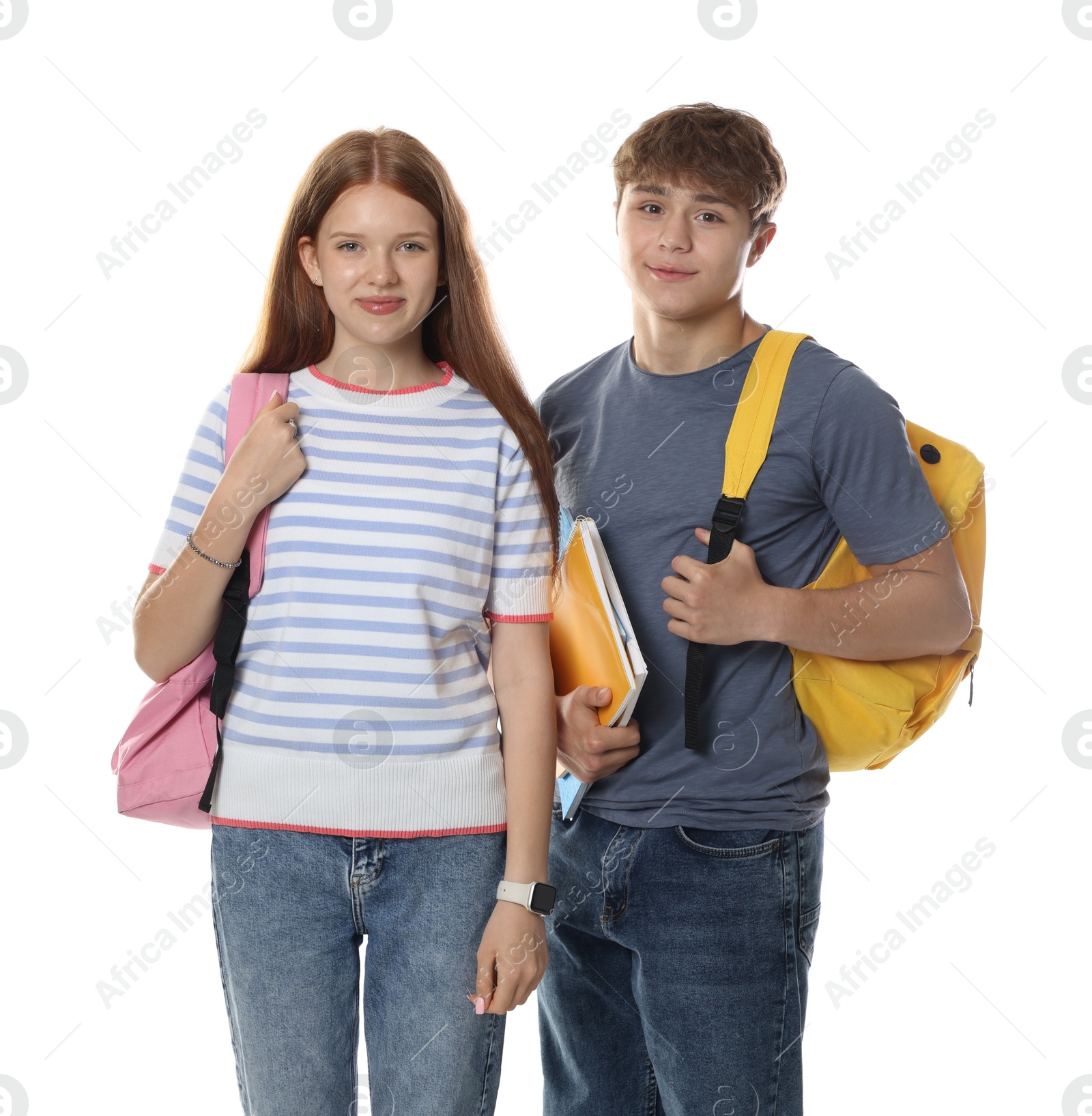 Teenage girl and boy with backpacks and notebooks on white background Photo of Teenage girl and boy with backpacks and notebooks on white background