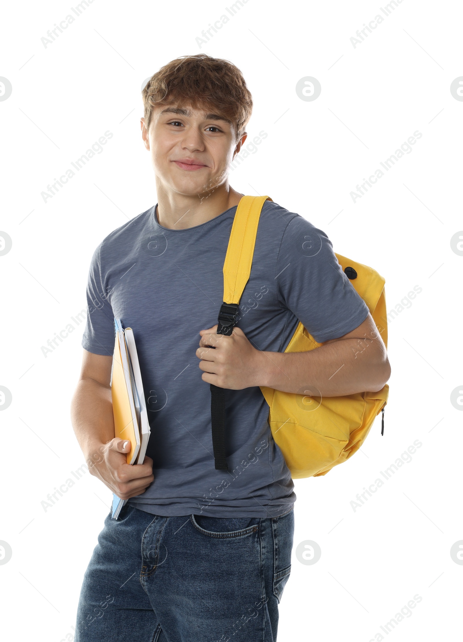 Photo of Cute teenage boy with backpack and notebooks on white background