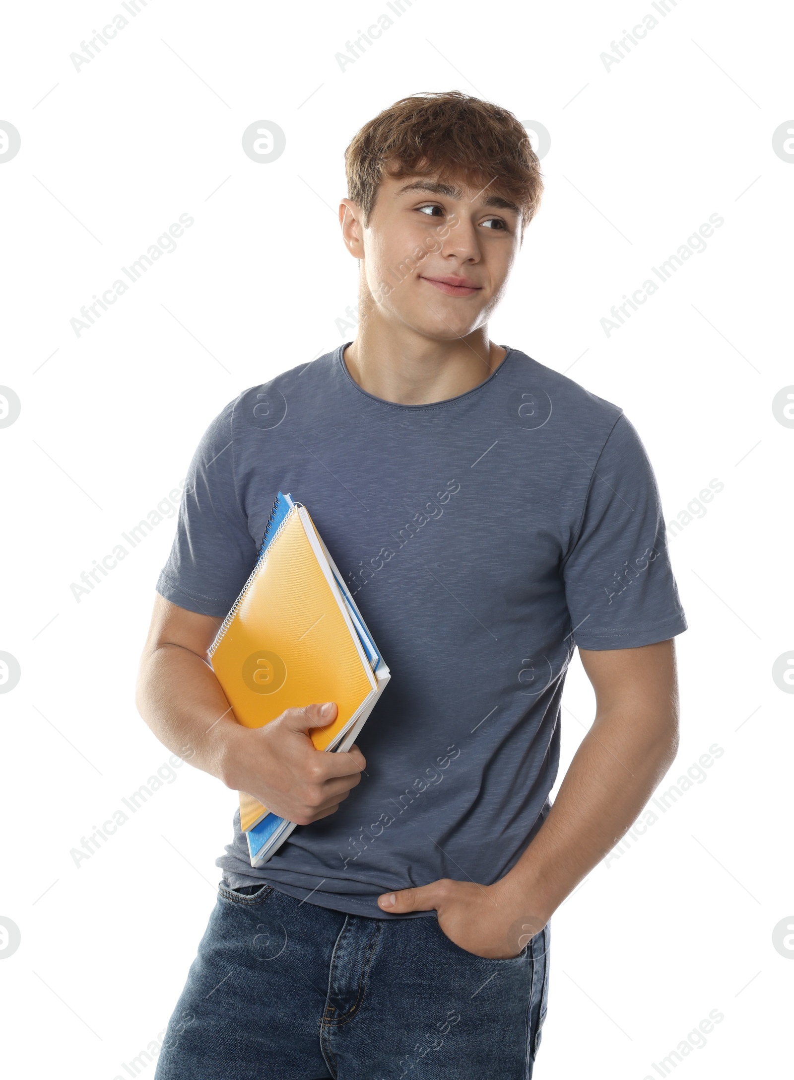 Cute teenage boy with notebooks on white background Photo of Cute teenage boy with notebooks on white background