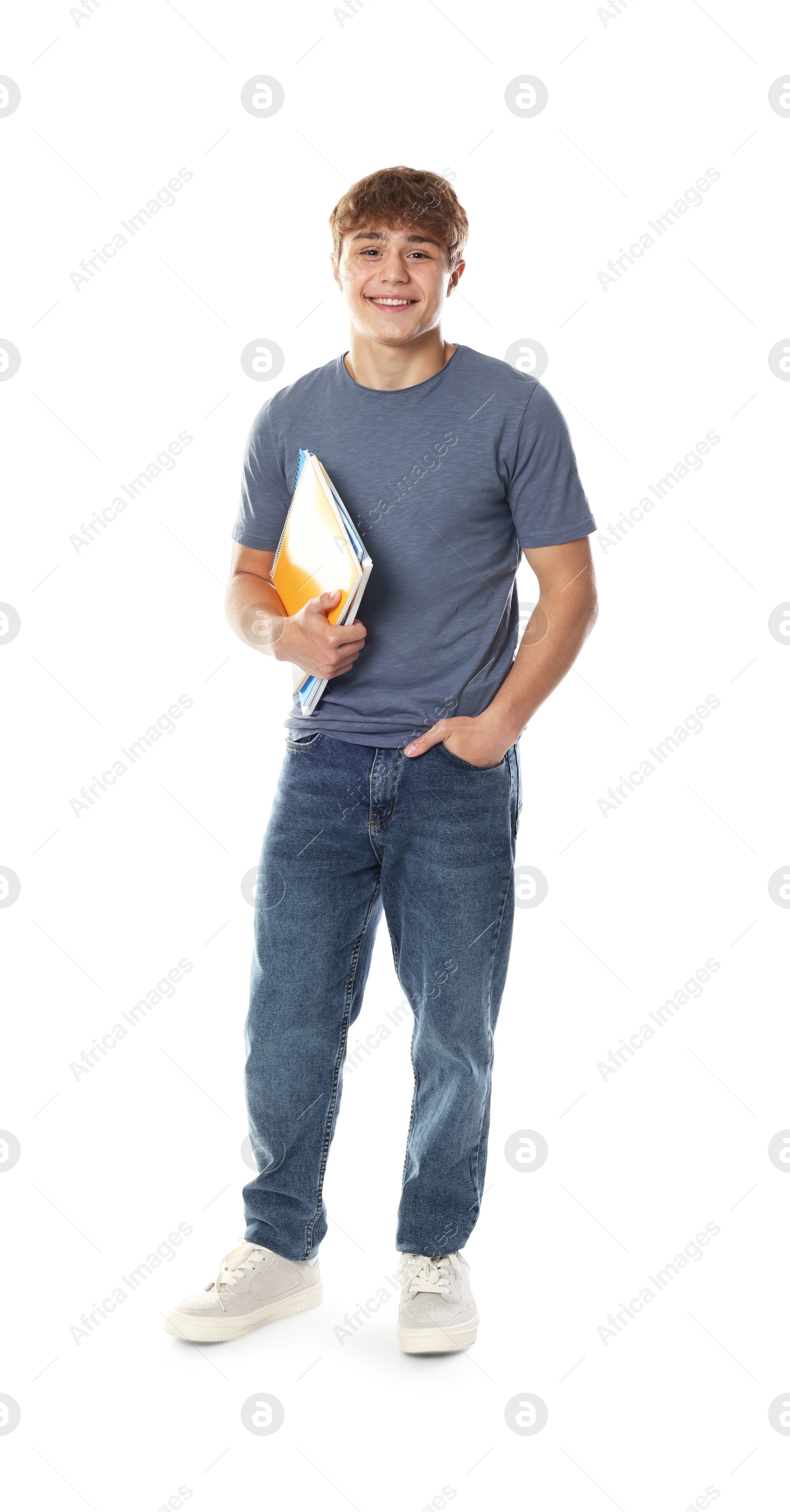 Photo of Cute teenage boy with notebooks on white background