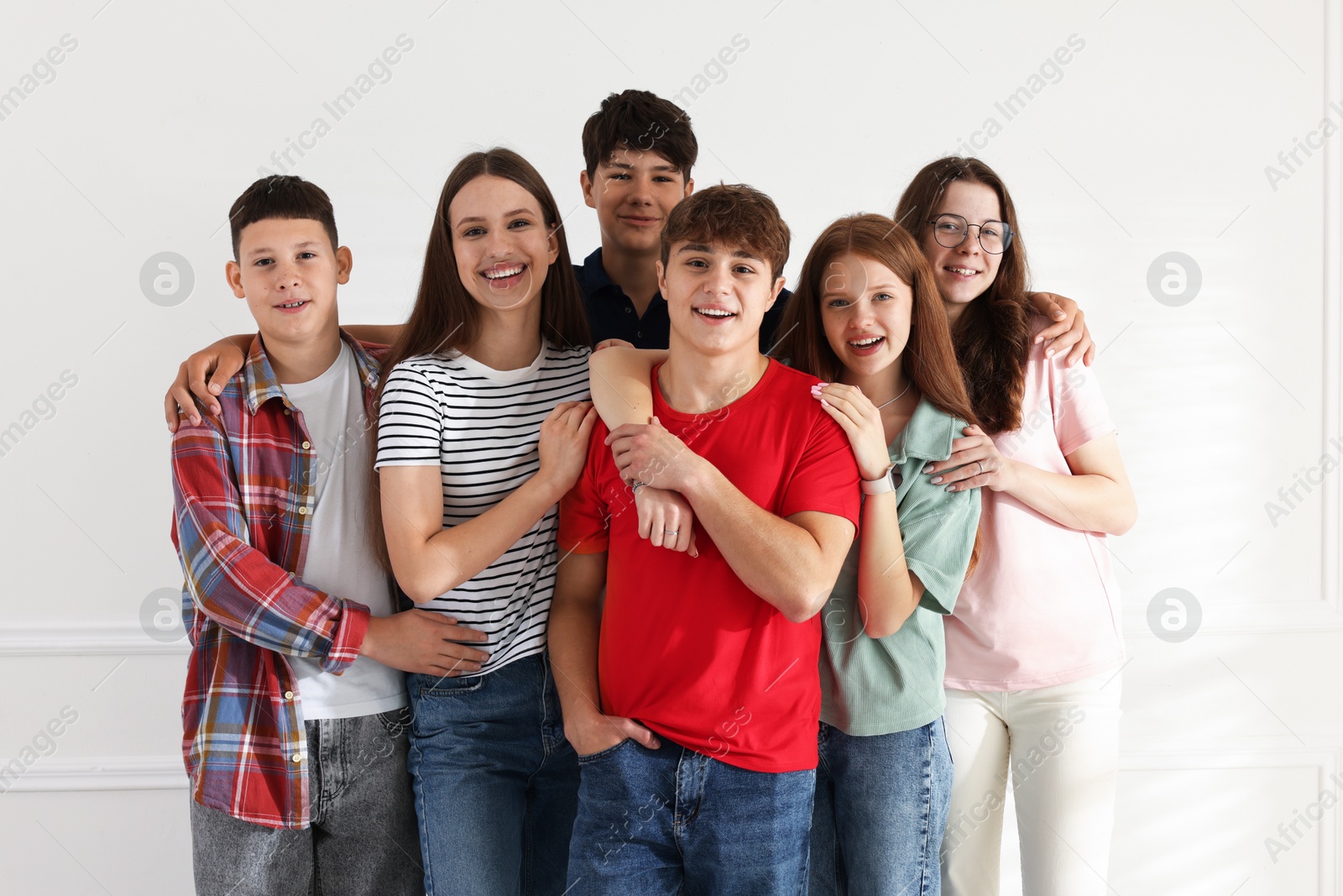 Group of happy teenagers posing together indoors Photo of Group of happy teenagers posing together indoors