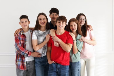 Photo of Group of happy teenagers posing together indoors
