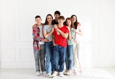 Photo of Group of happy teenagers posing together indoors