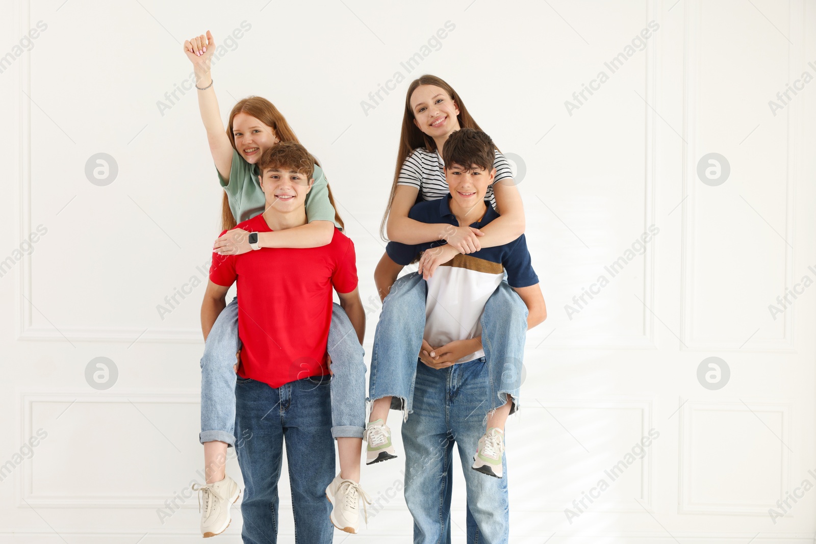 Group of teenagers having fun together indoors Photo of Group of teenagers having fun together indoors