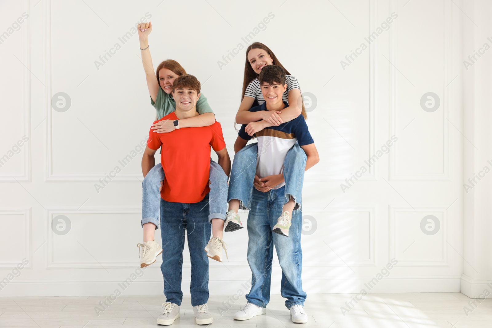 Group of teenagers having fun together indoors Photo of Group of teenagers having fun together indoors