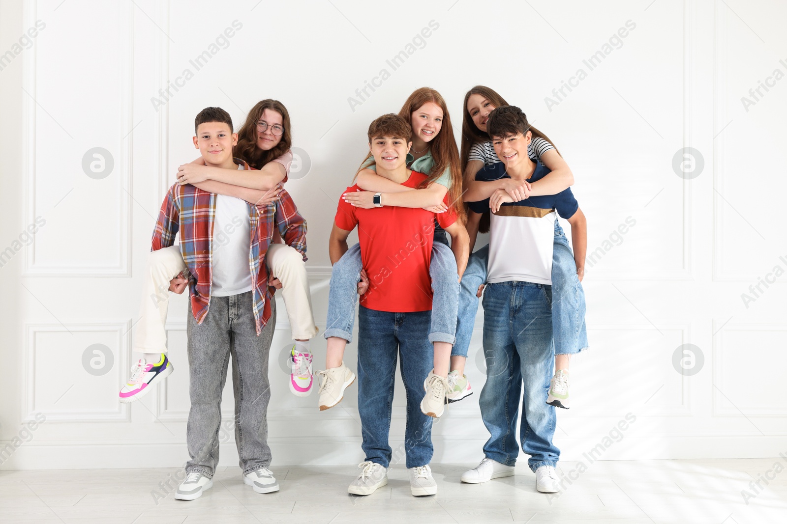Group of teenagers having fun together indoors Photo of Group of teenagers having fun together indoors