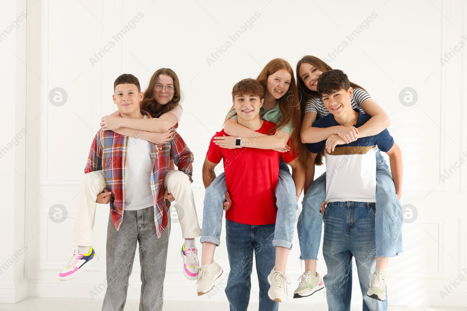 Group of teenagers having fun together indoors Photo of Group of teenagers having fun together indoors